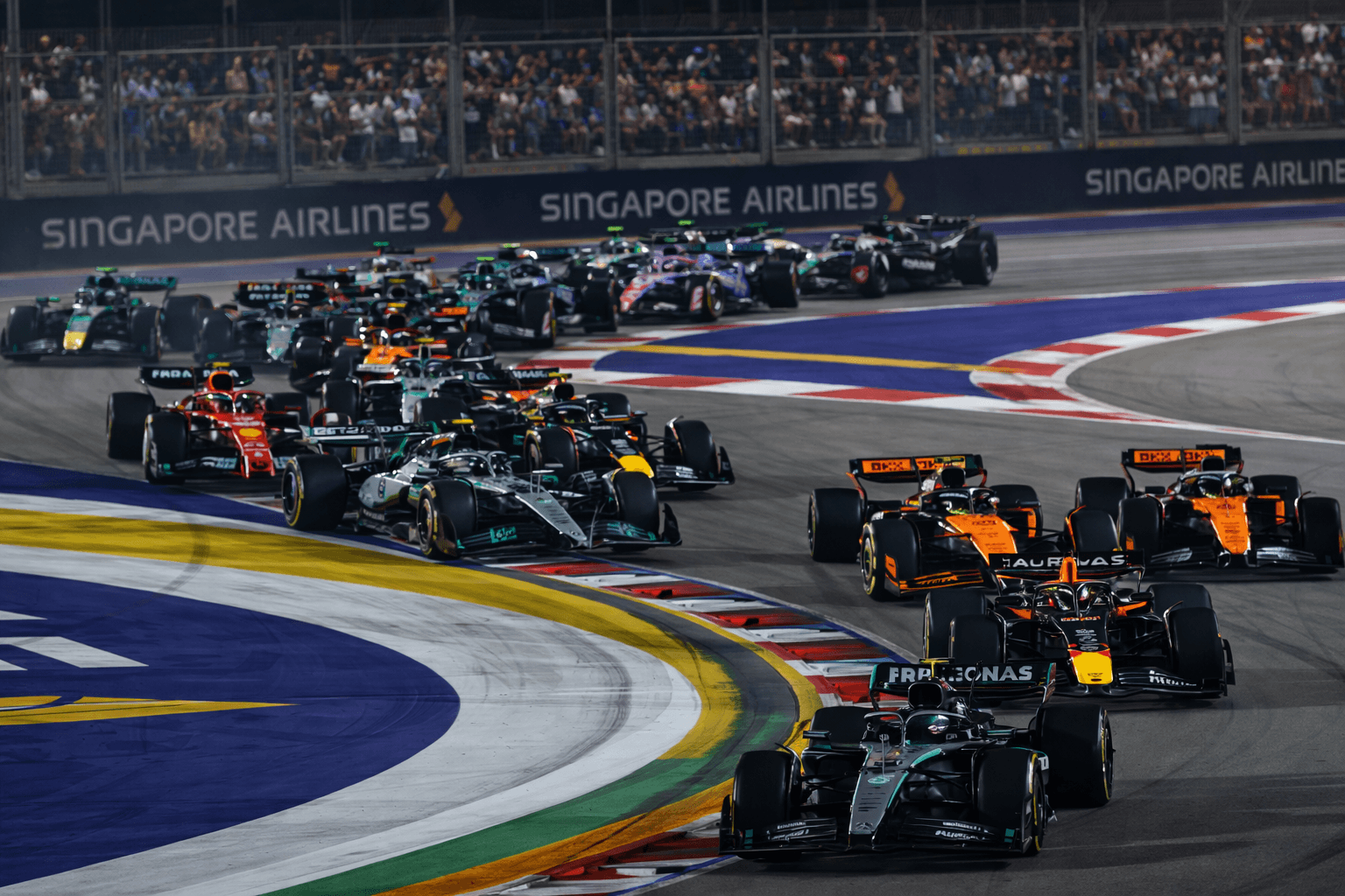 Formula 1 cars racing during the Singapore Grand Prix night race at Marina Bay